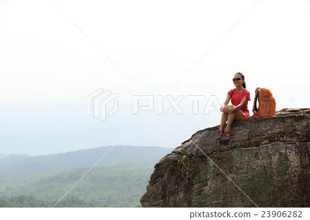 woman hiker enjoy the view on mountain top rock 23906282