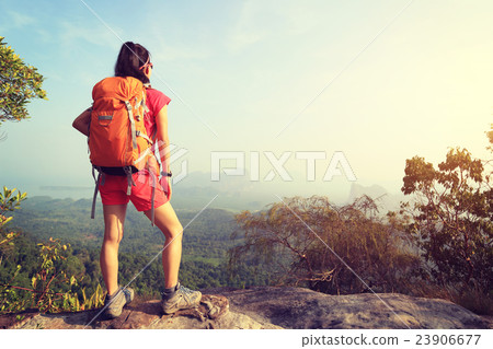 woman hiker enjoy the view on mountain top cliff 23906677