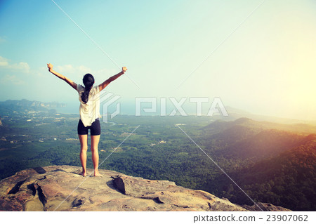 young freedom woman open arms on mountain peak.. young freedom woman open arms on mountain peak.. 23907062