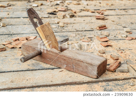Old wooden carpenter hand plane on wooden floor 23909630