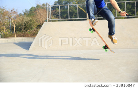 skateboarding woman practice ollie at skatepark 23910847