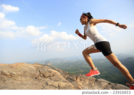 young asian woman runner running on mountain peak young asian woman runner running on mountain peak 23910853