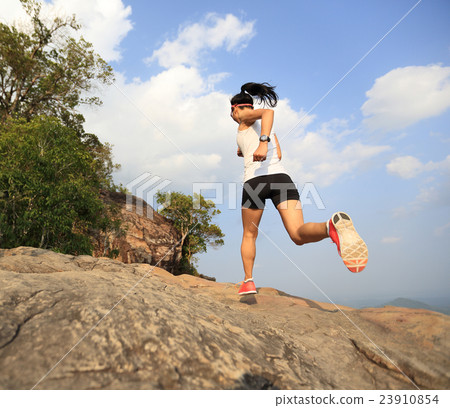 young asian woman runner running on mountain peak young asian woman runner running on mountain peak 23910854