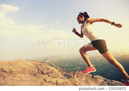 young asian woman runner running on mountain peak young asian woman runner running on mountain peak 23910855