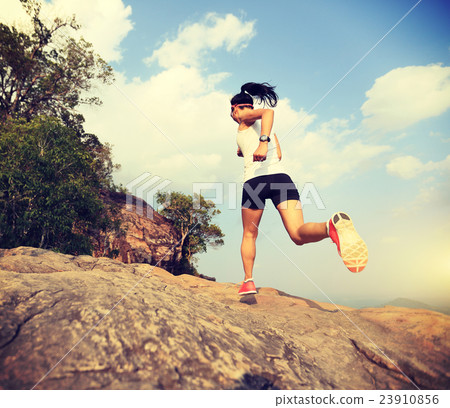 young asian woman runner running on mountain peak 23910856