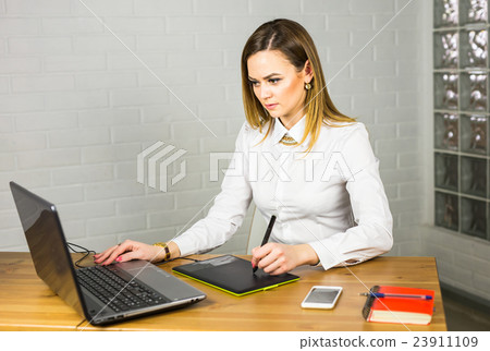 Graphic designer using digital tablet and computer 23911109