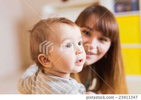 Portrait of happy mother and baby at home 23911347