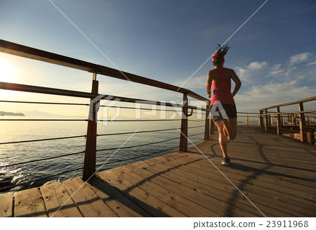 healthy   young woman runner running on trail 23911968