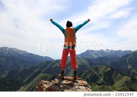 cheering young woman hiker open arms mountain peak 23912547