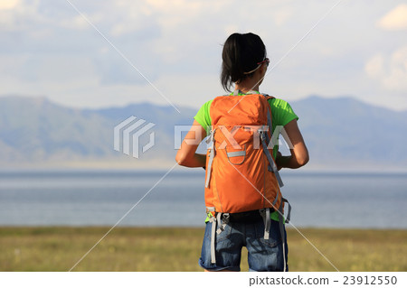 young woman hiker enjoy the view at seaside 23912550