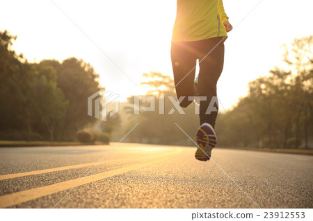 young fitness woman runner running on sunrise road 23912553
