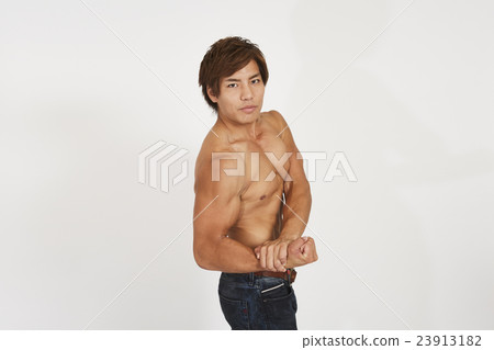 Macho young man showing muscle Macho young man showing muscle 23913182