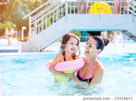 Mother and daughter in swimming pool, aquapark 23916651