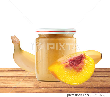 Jar of baby puree, peach and banana on wood table 23916669