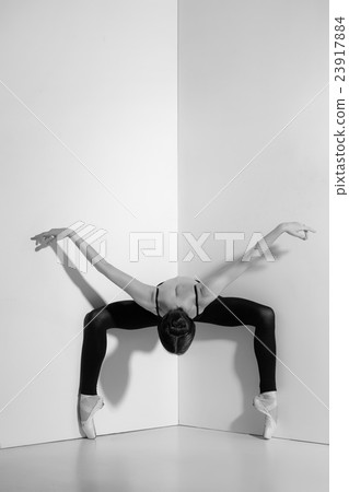 Ballerina in black outfit posing on pointe shoes Ballerina in black outfit posing on pointe shoes 23917884