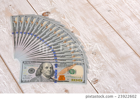 a bundle of money on the table 9 23922602
