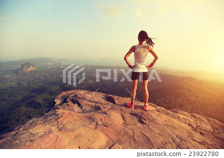 young  woman enjoy the view on mountain peak 23922780