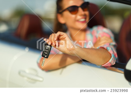 Woman sitting in a car with the keys in hand 23923998