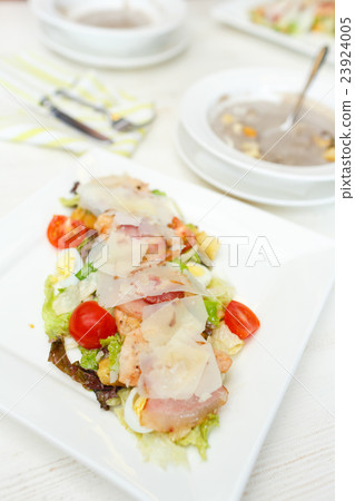 Healthy grilled chicken caesar salad with cheese and croutons Healthy grilled chicken caesar salad with cheese and croutons 23924005