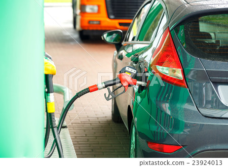 Car refueling on a petrol station Car refueling on a petrol station 23924013