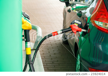 Car refueling on a petrol station Car refueling on a petrol station 23924014