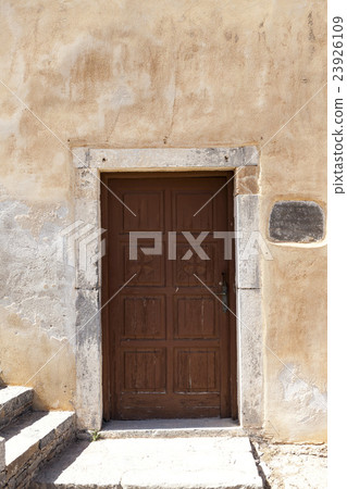 Old door in the stone walls of the village houses Old door in the stone walls of the village houses 23926109