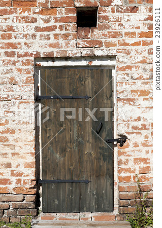 Old door in the stone walls of the village houses Old door in the stone walls of the village houses 23926111