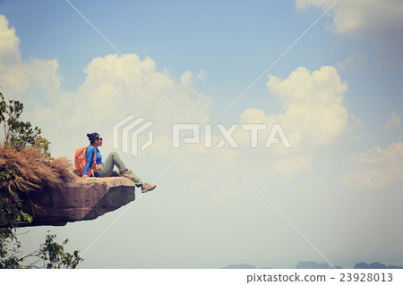 woman hiker at sunrise mountain peak 23928013