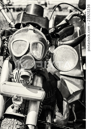 Detail of veteran motorbike with symbolic gas mask Detail of veteran motorbike with symbolic gas mask 23928236