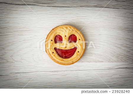 One round biscuit smiling face, humorous food 23928240