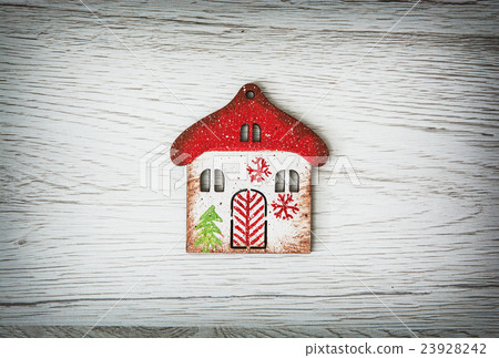 Little decorative house on the wooden background Little decorative house on the wooden background 23928242