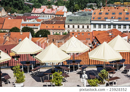 Empty tables, chairs and umbrellas in restaurant 23928352