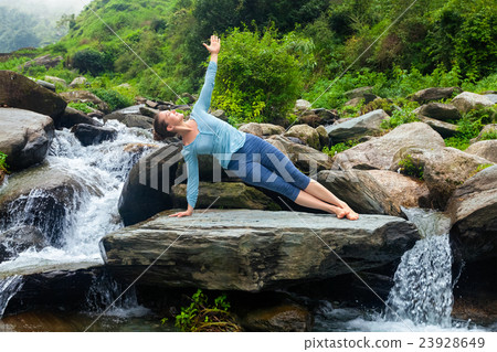 Woman doing yoga asana Vasisthasana - side plank Woman doing yoga asana Vasisthasana - side plank 23928649