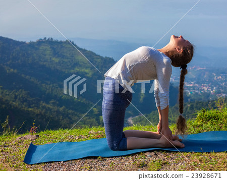 Woman doing yoga asana Ustrasana camel pose Woman doing yoga asana Ustrasana camel pose 23928671