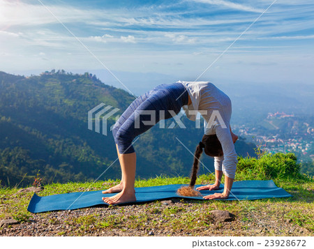 Woman doing Ashtanga Vinyasa Yoga asana Urdhva Woman doing Ashtanga Vinyasa Yoga asana Urdhva 23928672
