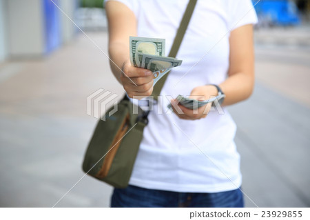 hands counting usd cash on street 23929855