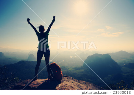 cheering woman hiker on sunrise mountain peak cheering woman hiker on sunrise mountain peak 23930018