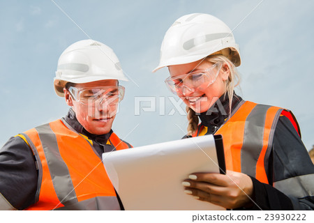 Two people working Two people working 23930222