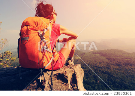 young woman hiker hiking on mountain peak cliff young woman hiker hiking on mountain peak cliff 23930361