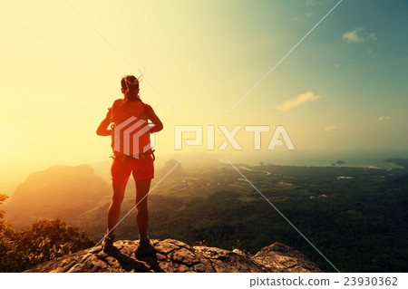 young woman hiker hiking on mountain peak cliff young woman hiker hiking on mountain peak cliff 23930362
