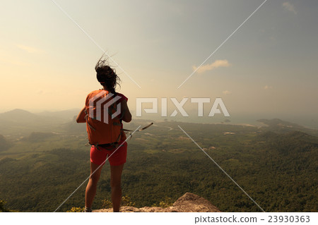 young woman hiker hiking on mountain peak cliff young woman hiker hiking on mountain peak cliff 23930363
