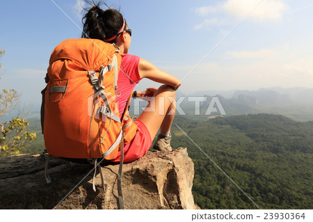 young woman hiker hiking on mountain peak cliff young woman hiker hiking on mountain peak cliff 23930364
