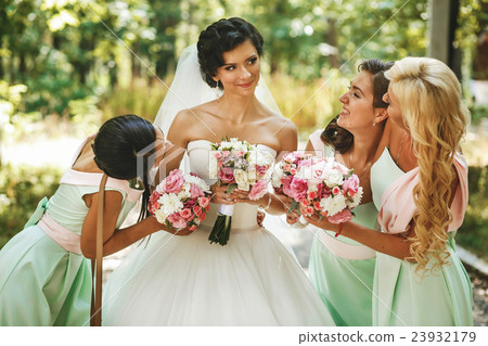 Bridesmaids admiring of bride 23932179