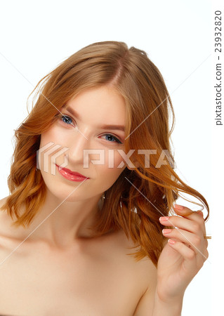 Pretty young woman with blue eyes and red lips plays with hair. 23932820