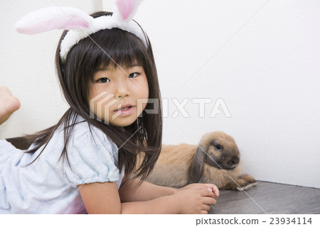 Girls playing with rabbits Girls playing with rabbits 23934114
