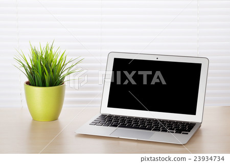 Office desk with laptop and plant Office desk with laptop and plant 23934734