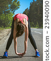 Young fitness woman runner stretching before run 23940090
