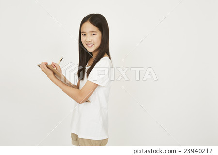 Elementary school student taking notes Elementary school student taking notes 23940212