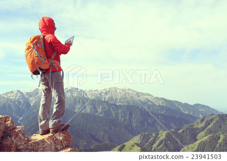 woman backpacker use digital tablet taking photo woman backpacker use digital tablet taking photo 23941503