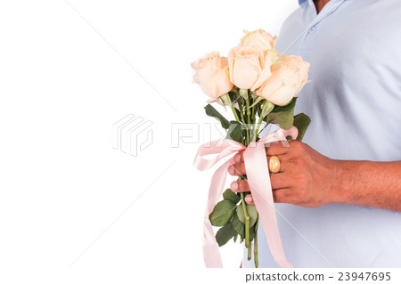 young man hold rose flower beind for surprise his wife young man hold rose flower beind for surprise his wife 23947695